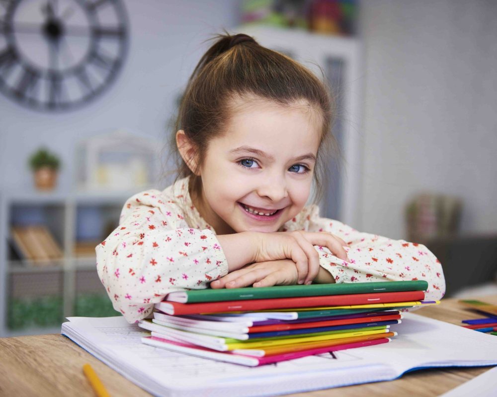 Smiling girl studying at home
